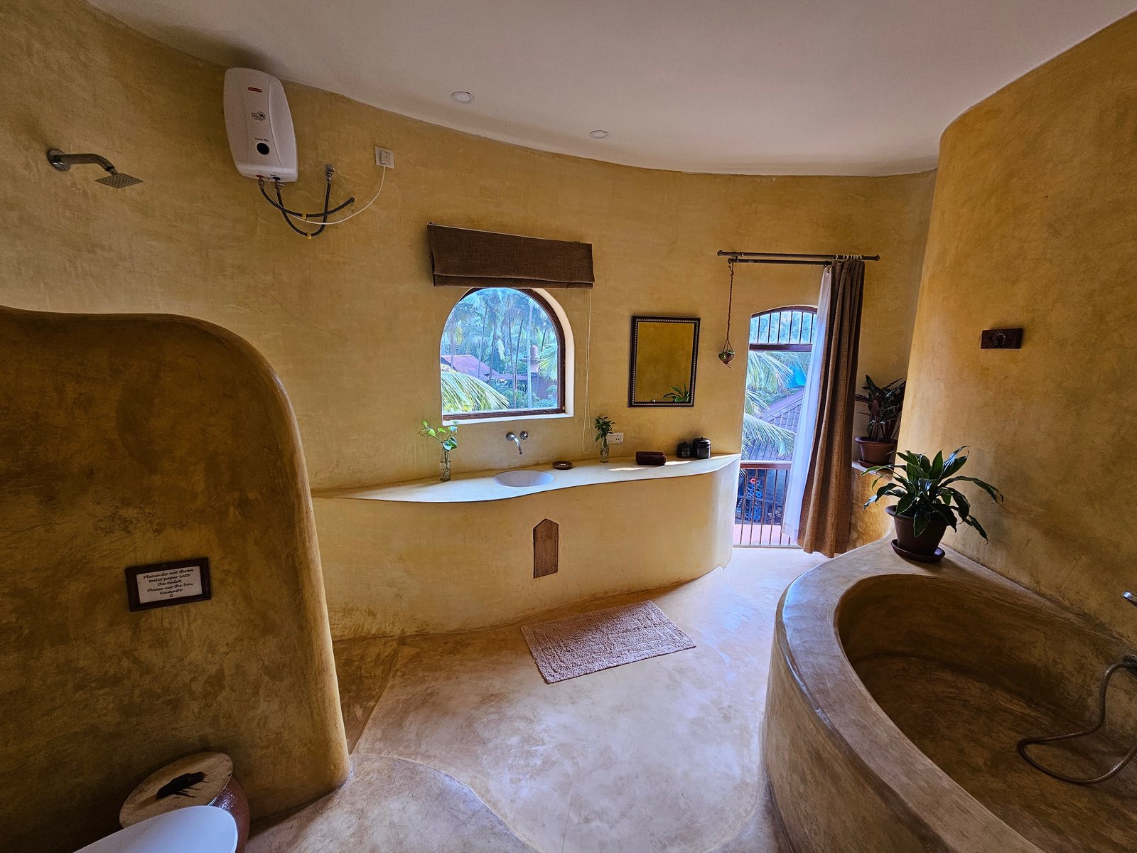 Bathroom with a sculpted stone bath